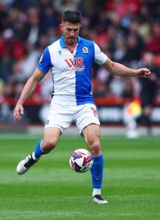 Danny Batth of Blackburn Rovers dribbling the ball during a soccer match.