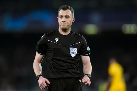 a referee wearing a black shirt that says match official