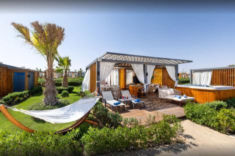 Rixos Radamis resort cabana with hot tub and hammock.