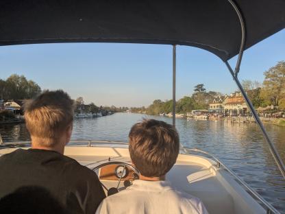 Two people on a boat on the Thames River.