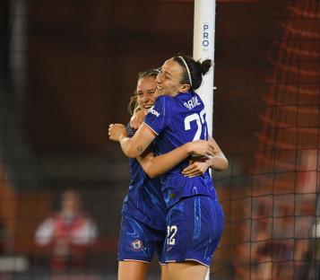Lucy Bronze of Chelsea celebrates with a teammate after scoring a goal.