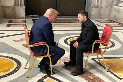 Donald Trump and Volodymyr Zelenskyy seated in chairs, in conversation.