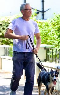 Gary Lineker walking his dog.