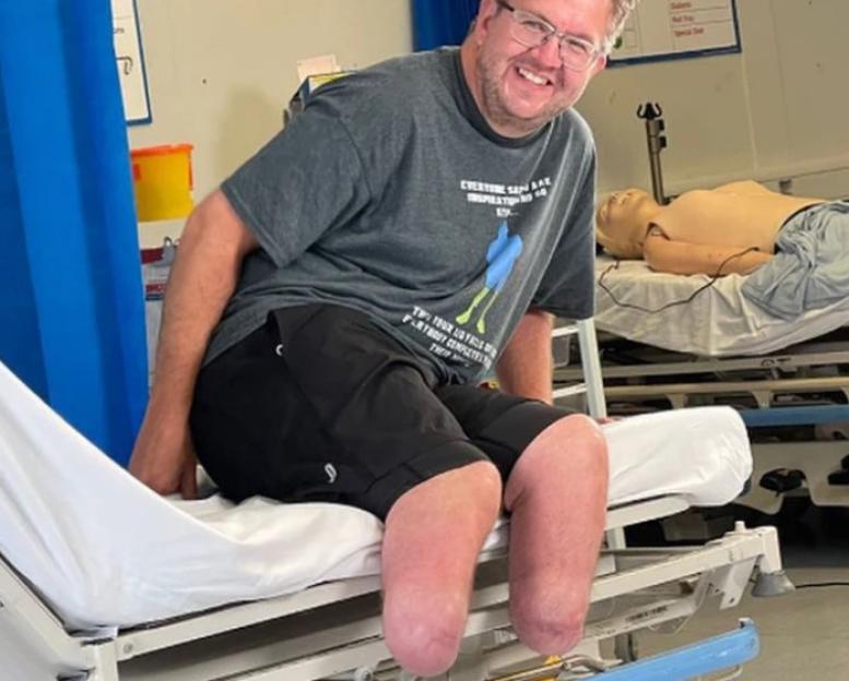 Surgeon Neil Hopper, who allegedly caused his own injuries, sitting on a hospital bed.