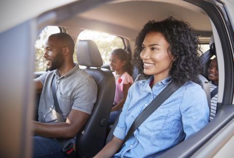 Black family on a road trip in a car.