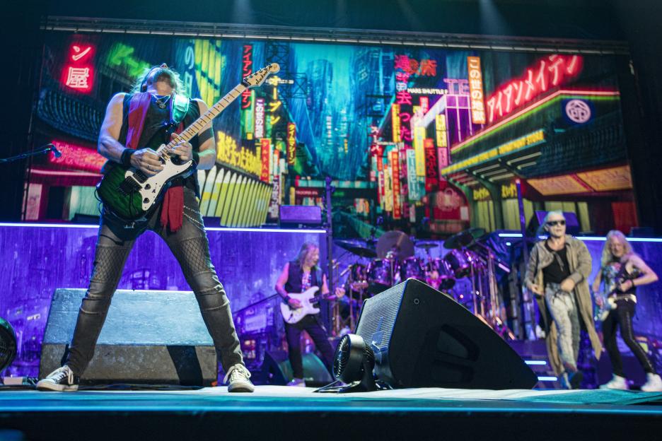 Adrian Smith of Iron Maiden performs on stage with other band members.
