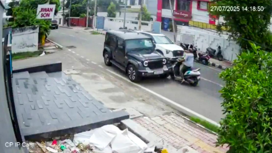 Security camera footage of a car hitting a scooter.