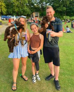Family with two dogs at an outdoor event.