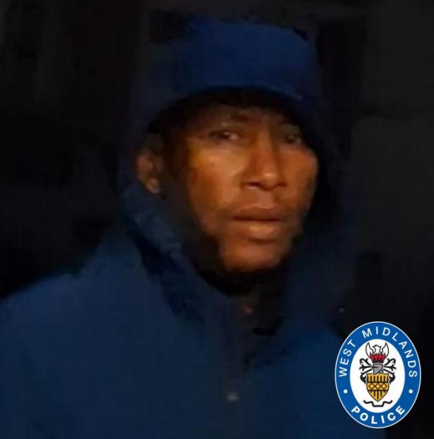 Still image of a male wearing a dark blue hooded jacket.