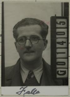 Black and white mugshot of a man wearing glasses.