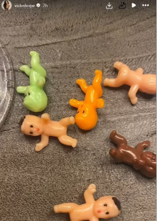 Several small plastic baby dolls lying on a surface.