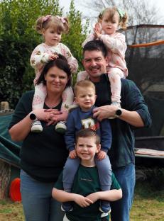 Family portrait of parents with their five children.