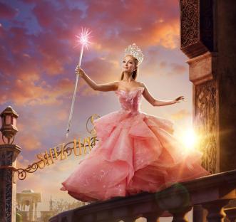 Ariana Grande as Glinda in Wicked, holding a wand.