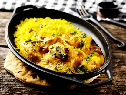 Chicken korma with yellow rice and naan bread.