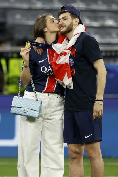 Khvicha Kvaratskhelia of PSG and his wife Nitsa Tavadze celebrating a UEFA Champions League win.