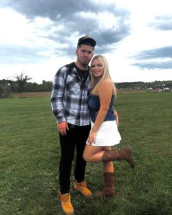 Couple posing outdoors.