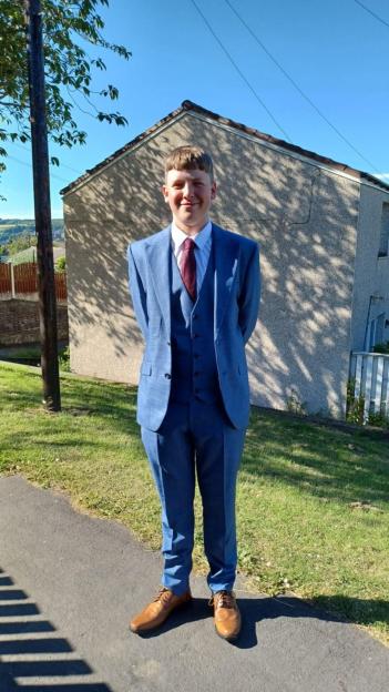 Josh Atkins in a blue suit.