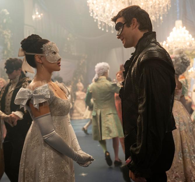 Yerin Ha as Sophie Baek and Luke Thompson as Benedict Bridgerton at a masquerade ball.
