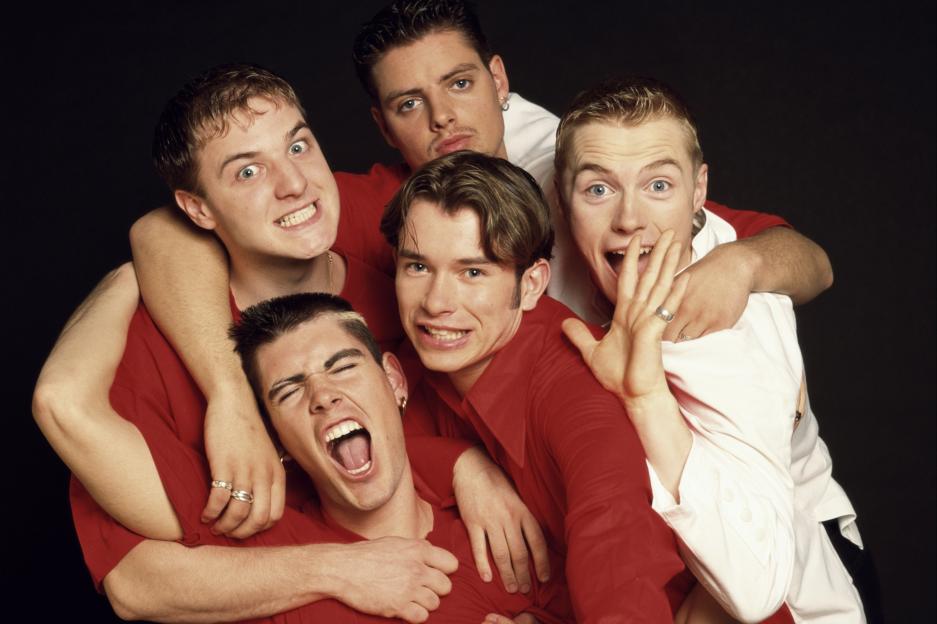 Boyzone members Mikey Graham, Keith Duffy, Ronan Keating, Stephen Gately, and Shane Lynch in a group photo from 1995.