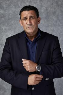 Portrait of Steven Gillen, ex-gangster, wearing a dark navy blazer and blue shirt.