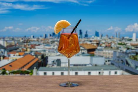 Spritz cocktail on a table overlooking Milan.