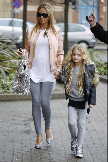 Katie Price and her daughter Princess walking hand-in-hand.