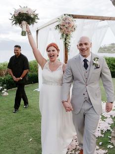 Newlyweds walking down the aisle after their Maui wedding ceremony.