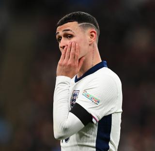 Phil Foden of England looking upset during a soccer match.