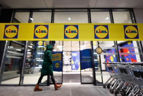 A person walks past the entrance of a Lidl store in Riga, Latvia.