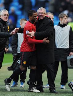 Sir Alex Ferguson and Patrice Evra embracing after a Manchester United soccer match.