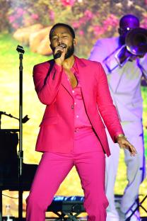 John Legend performing on stage.