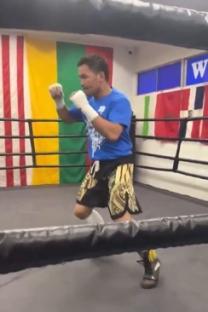 Boxer shadow boxing in a ring.
