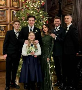 The Beckham family photo in front of a Christmas tree.