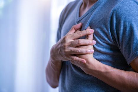 Man holding his chest in pain.