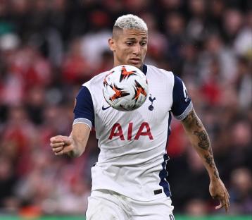 Richarlison of Tottenham Hotspur controlling the ball during a soccer match.
