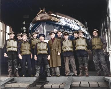 Colorized photo of RNLI crew with lifeboat.