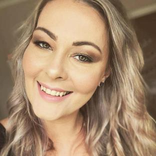 Close-up portrait of a woman with blonde hair and makeup.