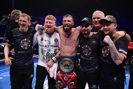 Anthony Cacace with his coaching staff after a boxing victory.