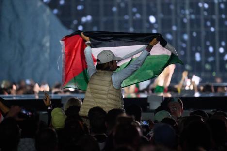Protestor waves Palestinian flag at Eurovision Song Contest.
