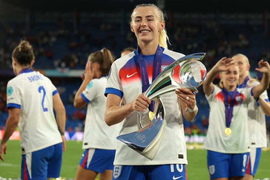 Chloe Kelly of England beams as she holds up the UEFA Women's EURO trophy.