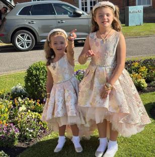 Two girls in floral dresses.