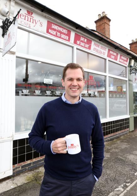 Robert Jenrick MP holds a mug with "Jenny's" logo outside Jenny's Cafe.