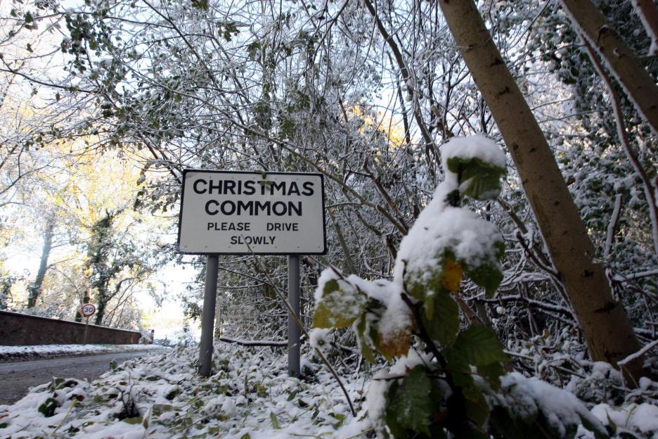A sign in the snow reads "Christmas Common, Please Drive Slowly."