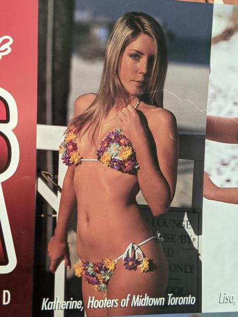 Photo of Katherine, a Hooters of Midtown Toronto employee, wearing a flower-adorned bikini.