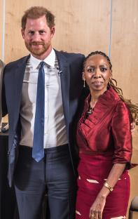Group photo of Prince Harry and four other individuals at a panel discussion.