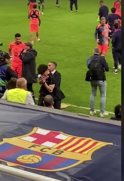A pitch invader being tackled by security on a soccer field, with a Barcelona FC banner in the foreground.