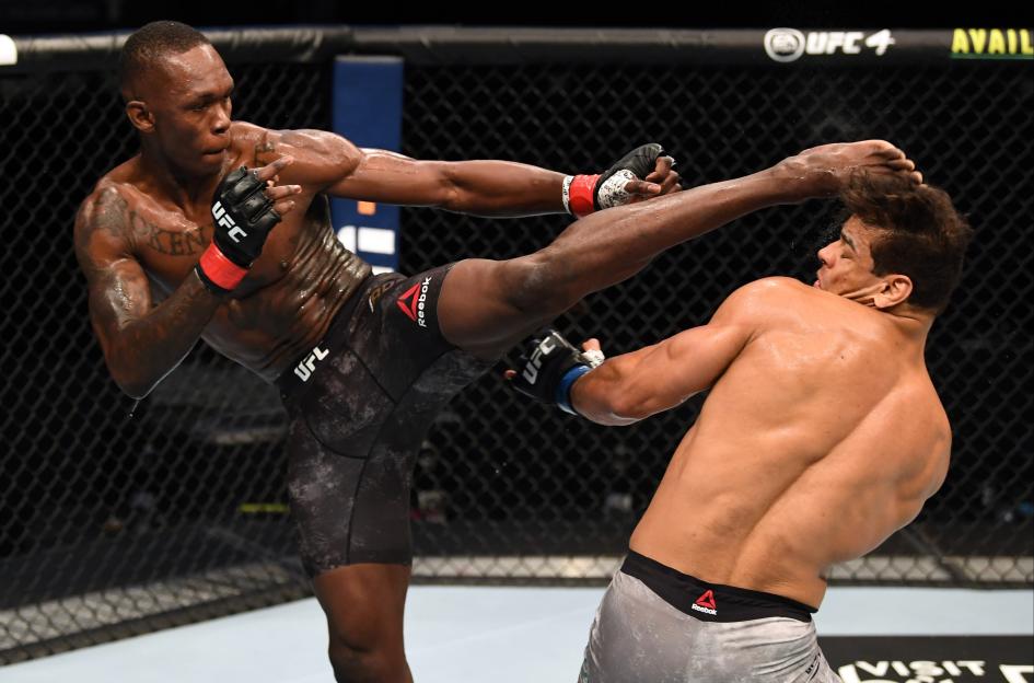 Israel Adesanya kicking Paulo Costa in a UFC middleweight championship bout.