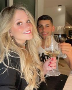 Couple toasting with wine glasses.