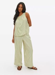 Woman in green and white striped pants and top.