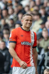 Carlton Morris of Luton Town smiling at a soccer match.